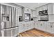 Bright kitchen features stainless steel appliances, white cabinets, and wood floors at 8740 15Th N St, St Petersburg, FL 33702