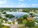 Breathtaking aerial view of a waterfront property with a boat dock, and lush landscaping at 8848 Sunlit Cove Ne Dr, St Petersburg, FL 33702
