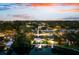 Aerial view of the property featuring a private backyard, pool, boat dock, and waterfront access at 8848 Sunlit Cove Ne Dr, St Petersburg, FL 33702