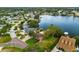 A waterfront property showing lush trees and landscaping, a private pool, and easy access to the water at 8848 Sunlit Cove Ne Dr, St Petersburg, FL 33702