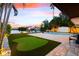 Backyard features a putting green, waterfront views, swimming pool, and boat dock for ultimate outdoor enjoyment at 8848 Sunlit Cove Ne Dr, St Petersburg, FL 33702