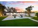 Outdoor living with private backyard, beautiful pool and lush green lawn at 8848 Sunlit Cove Ne Dr, St Petersburg, FL 33702