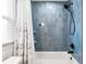Close up of the modern shower with rainfall shower head and shower curtain at 8848 Sunlit Cove Ne Dr, St Petersburg, FL 33702