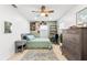 Cozy bedroom featuring a ceiling fan, area rug, and desk with natural light at 8848 Sunlit Cove Ne Dr, St Petersburg, FL 33702