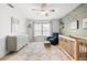 Inviting Bedroom with accent wall, crib, and comfortable sitting area at 8848 Sunlit Cove Ne Dr, St Petersburg, FL 33702
