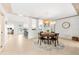 Open dining room with round table, pendant light, flowing to the kitchen and living areas at 8848 Sunlit Cove Ne Dr, St Petersburg, FL 33702