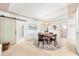 Bright dining room showcasing modern lighting, a round table, and a sliding barn door feature at 8848 Sunlit Cove Ne Dr, St Petersburg, FL 33702