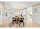 Cozy dining area features a round table, pendant light, and seamless flow to kitchen at 8848 Sunlit Cove Ne Dr, St Petersburg, FL 33702