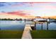 Picturesque view of the boat dock with a boat lift and water access for boating enthusiasts at 8848 Sunlit Cove Ne Dr, St Petersburg, FL 33702