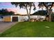 Charming single-story home featuring a manicured lawn, beautiful landscaping, and a two-car garage at 8848 Sunlit Cove Ne Dr, St Petersburg, FL 33702