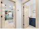 Hallway shows a bedroom and a bathroom with wood floors and light walls at 8848 Sunlit Cove Ne Dr, St Petersburg, FL 33702