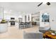 Open kitchen with white cabinetry, stainless appliances, breakfast bar, and adjacent dining area at 8848 Sunlit Cove Ne Dr, St Petersburg, FL 33702