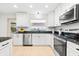 Bright kitchen features granite countertops, stainless steel appliances, and white cabinetry at 8848 Sunlit Cove Ne Dr, St Petersburg, FL 33702