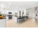 Spacious kitchen with white cabinetry, granite countertops, and a breakfast bar with seating at 8848 Sunlit Cove Ne Dr, St Petersburg, FL 33702