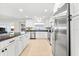 Modern kitchen with stainless steel appliances, granite countertops, and ample cabinet space at 8848 Sunlit Cove Ne Dr, St Petersburg, FL 33702
