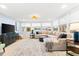 Bright living room featuring large windows, waterfront views, neutral tones and a decorative area rug at 8848 Sunlit Cove Ne Dr, St Petersburg, FL 33702