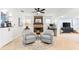 Cozy living room with a stone fireplace, comfortable seating, and natural light at 8848 Sunlit Cove Ne Dr, St Petersburg, FL 33702