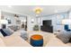 Living room featuring modern decor, neutral tones, a decorative rug, and an open floor plan at 8848 Sunlit Cove Ne Dr, St Petersburg, FL 33702