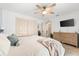Spacious main bedroom with light wood floors, a ceiling fan, a closet and contemporary decor at 8848 Sunlit Cove Ne Dr, St Petersburg, FL 33702