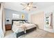 The main bedroom features a ceiling fan, natural light and a closet with a mirror at 8848 Sunlit Cove Ne Dr, St Petersburg, FL 33702