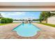 Beautiful swimming pool with brick pavers and a view of the boat lift on the water at 8848 Sunlit Cove Ne Dr, St Petersburg, FL 33702