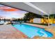 Inviting pool and patio area with waterfront view and easy access to the boat dock offers outdoor relaxation at 8848 Sunlit Cove Ne Dr, St Petersburg, FL 33702