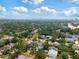 Aerial view of the community showing houses, tree coverage, and city skyline in the distance at 911 S Sterling Ave, Tampa, FL 33629