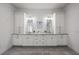 Bathroom boasts double sinks, white cabinets, tile flooring and ample storage at 911 S Sterling Ave, Tampa, FL 33629