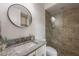 Bright bathroom with granite countertop, modern fixtures, decorative mirror, and glass-enclosed shower stall at 911 S Sterling Ave, Tampa, FL 33629