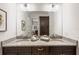 Bathroom featuring a double vanity with granite countertops and large mirror at 911 S Sterling Ave, Tampa, FL 33629