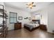 Comfortable bedroom features wood floors, ceiling fan, stylish furnishings, and natural light from window at 911 S Sterling Ave, Tampa, FL 33629