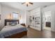 Cozy bedroom with built-in shelving, wood floors, accent lighting, and comfortable bed at 911 S Sterling Ave, Tampa, FL 33629