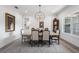 Formal dining room with wooden table, six chairs, chandelier, and large window at 911 S Sterling Ave, Tampa, FL 33629