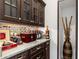 Elegant dry bar featuring wine and liquor storage, and granite countertops at 911 S Sterling Ave, Tampa, FL 33629