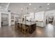 Spacious kitchen with a large island, granite countertops, stainless steel appliances, and custom cabinetry at 911 S Sterling Ave, Tampa, FL 33629