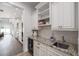 A kitchenette with a granite countertop and mini fridge; perfect for guests or Gathering members at 911 S Sterling Ave, Tampa, FL 33629