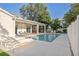 Beautiful backyard in-ground pool with lounge chairs and covered outdoor dining area at 911 S Sterling Ave, Tampa, FL 33629