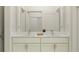 Bright bathroom with a double sink vanity featuring a white marble countertop and a separate shower at 9406 Gladsome Dr, Land O Lakes, FL 34637
