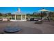 Community playground featuring swings, slides, benches, and a covered picnic area at 9406 Gladsome Dr, Land O Lakes, FL 34637