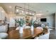 Dining area with table and view into the kitchen and living room for open-concept living at 9997 Surrey Rose Dr, San Antonio, FL 33576