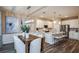 The dining area is adjacent to the kitchen and features a modern chandelier and large abstract art at 9997 Surrey Rose Dr, San Antonio, FL 33576