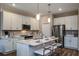 The kitchen has white cabinets, stainless steel appliances, and a center island with bar seating at 9997 Surrey Rose Dr, San Antonio, FL 33576