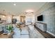 Open concept kitchen, dining and living area with gray sectional and modern finishes at 9997 Surrey Rose Dr, San Antonio, FL 33576