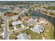 Expansive aerial view of a residential neighborhood with mature landscaping, serene lakes, and well-maintained homes at 106 Silverbell Ct, Sun City Center, FL 33573