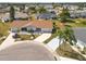 Aerial view of a home with a well-maintained lawn and charming curb appeal at 106 Silverbell Ct, Sun City Center, FL 33573