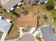 Birds eye view of a single Gathering home with landscaped yard including mature trees, mulched beds and a curved driveway at 106 Silverbell Ct, Sun City Center, FL 33573