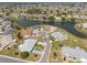 Aerial view of a quiet neighborhood with houses surrounding a pond at 106 Silverbell Ct, Sun City Center, FL 33573