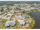 Community aerial showcasing homes nestled around a picturesque lake at 106 Silverbell Ct, Sun City Center, FL 33573