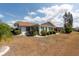 A well-kept backyard with mature landscaping complements this charming home at 106 Silverbell Ct, Sun City Center, FL 33573