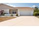 Charming single-story home featuring a two-car garage and well-maintained front yard at 106 Silverbell Ct, Sun City Center, FL 33573